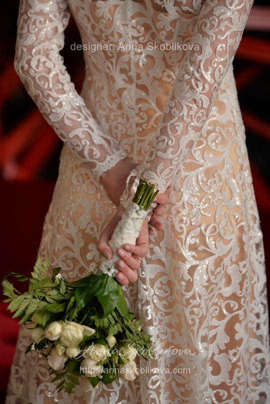 Dense lace wedding dress with long sleeves by Anna Skoblikova